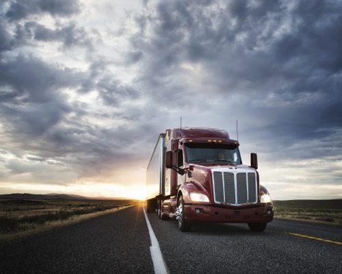 3/4 front view of a  commercial truck on the road at sunset  in eastern Washington, USA